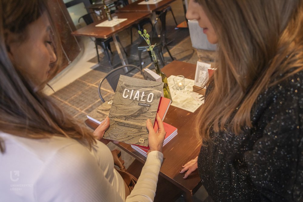 uczestnicy spotkania oglądają książkę Ciało i społeczeństwo